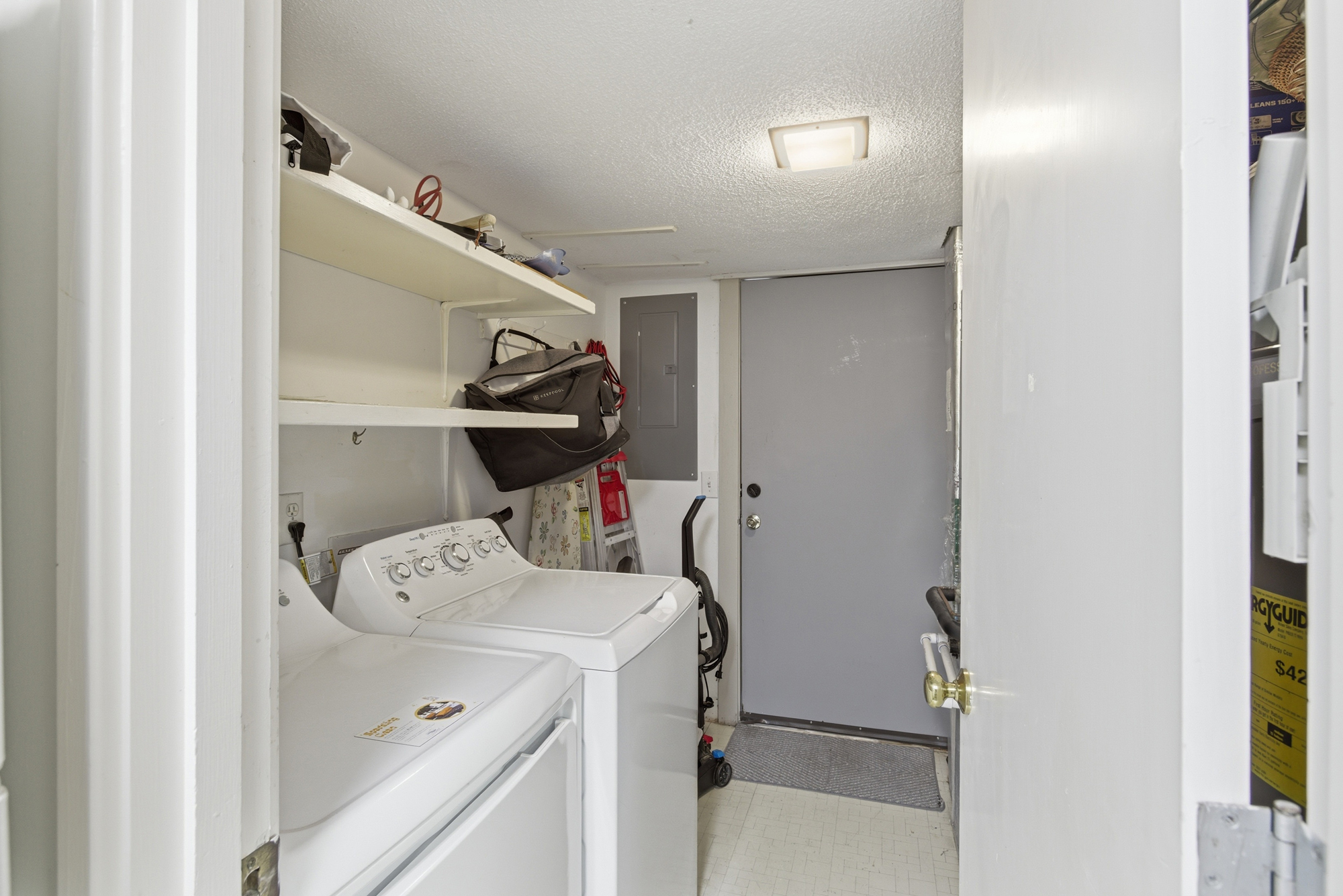 Practical utility meets homey convenience in this dedicated laundry nook, featuring modern appliances and ample shelving for your travel essentials. Bright overhead lighting keeps the space functional and ready for quick refreshes during your stay.