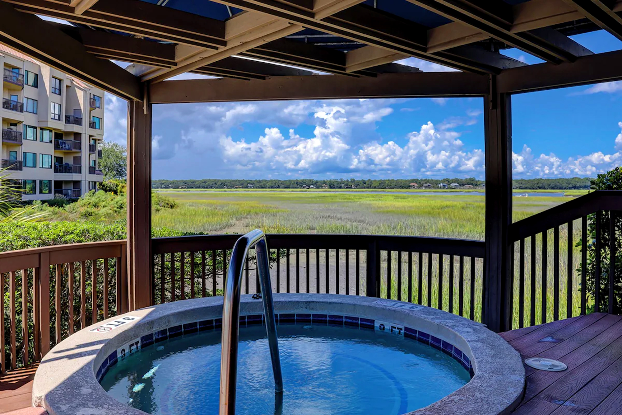 Covered hot tub creates a serene spot to soak while watching the afternoon glow settle over the grassy wetlands and catching glimpses of sea life!